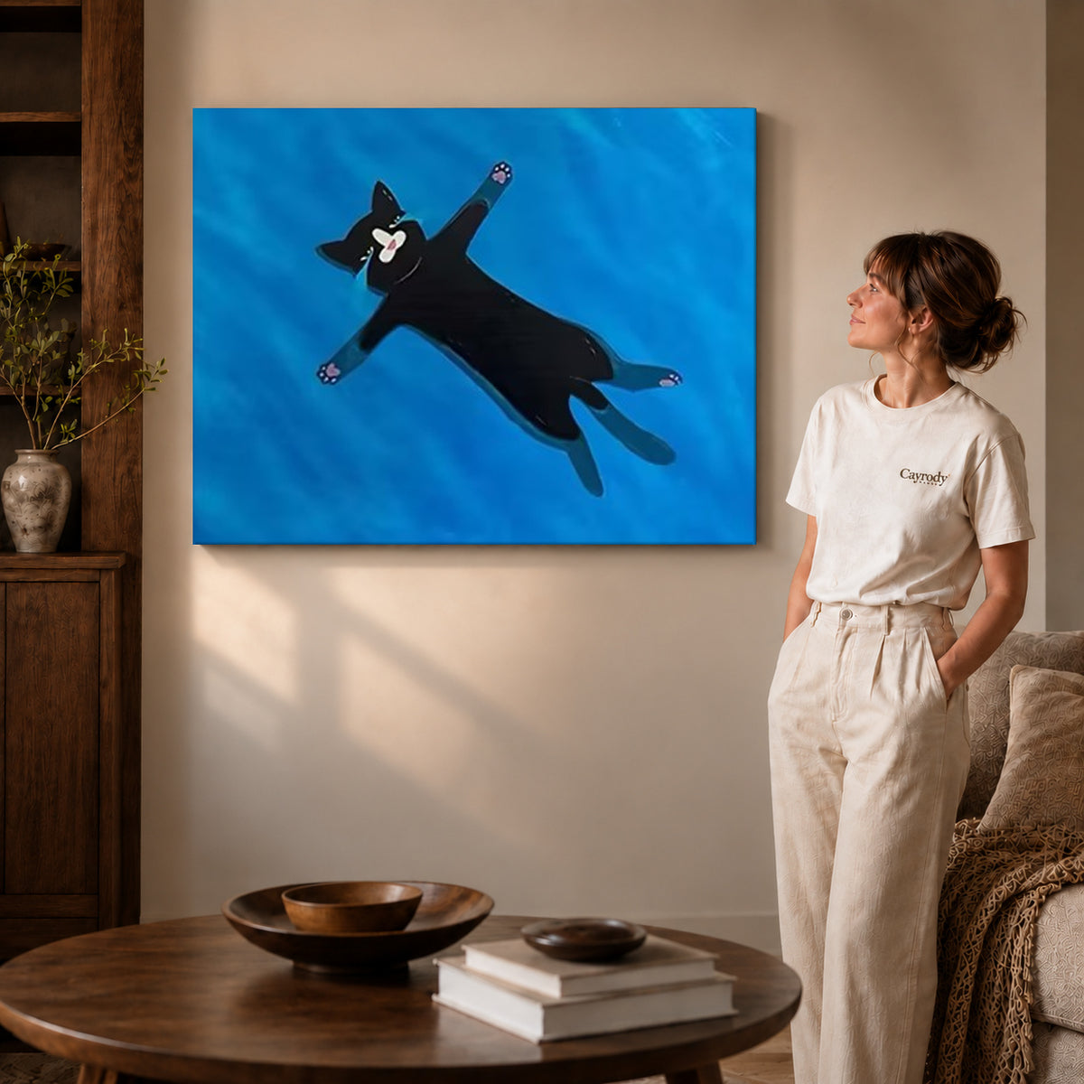 Floating black cat canvas art on unframed wrapped canvas, showing natural edge depth against the living room wall.
