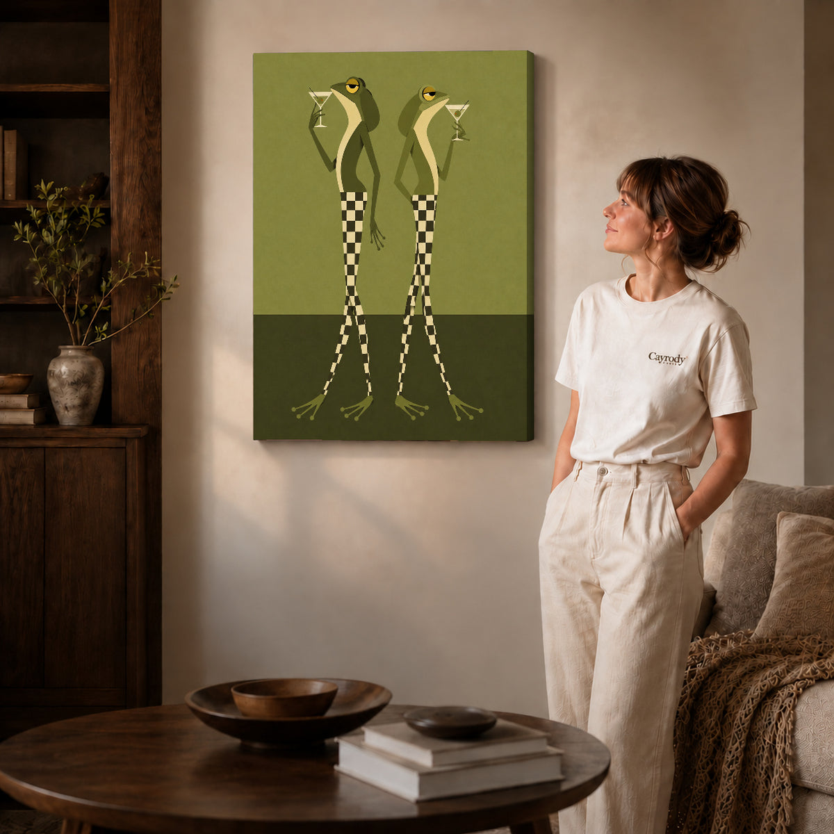 Gallery wrapped martini frogs canvas art with visible canvas edges beside a standing woman.