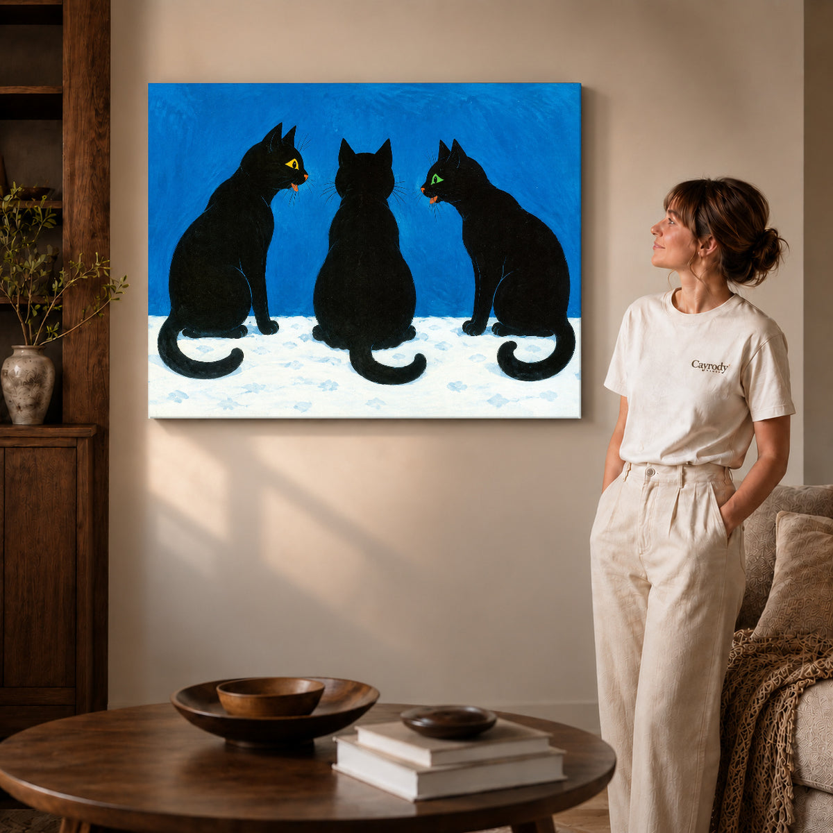 Gallery wrapped black cat canvas art showing dimensional edges and soft shadows in a living room.
