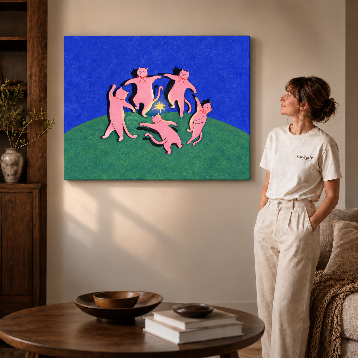 Gallery wrapped dancing cats canvas art showing dimensional edges and soft shadows in a living room.