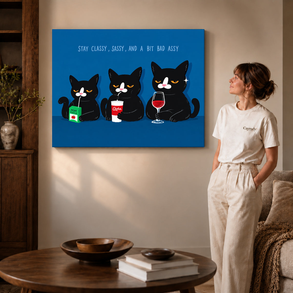 Gallery wrapped sassy cat trio canvas art showing dimensional edges and soft shadows in a living room.