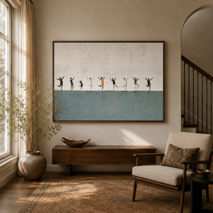 Framed minimalist dancing figures canvas wall art above a wood console in a bright neutral entryway