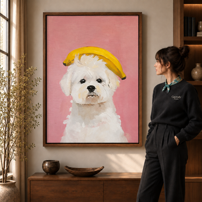 Whimsical banana dog canvas art in a walnut frame beside a woman wearing a scarf.