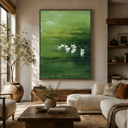 Impressionist white geese green lake canvas print displayed in warm neutral living room above wooden credenza