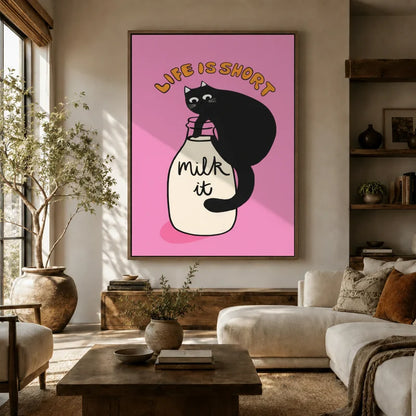 Bold pink black cat canvas wall art hung above a sofa in a warm boho living room with earthy tones