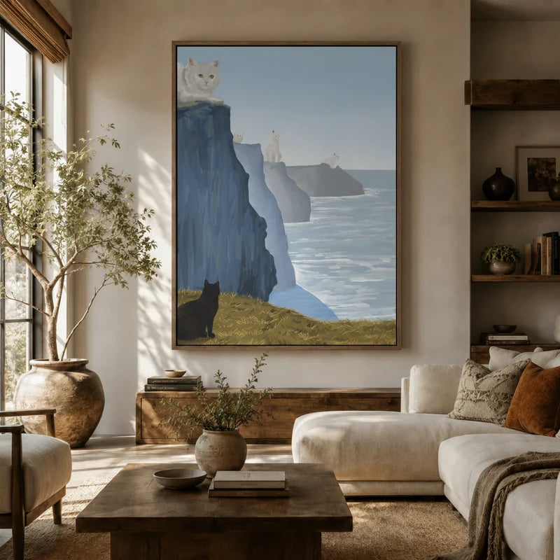 Oversized coastal cat landscape in floater frame above a white sofa in a sunlit organic modern living room