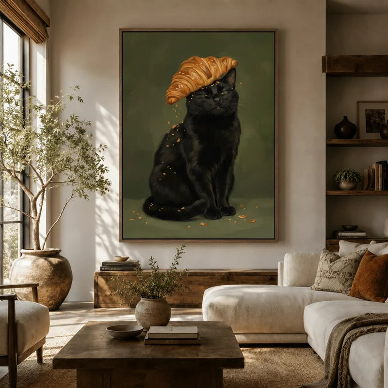 Black cat croissant portrait canvas art hanging above a sofa in a boho-organic living room