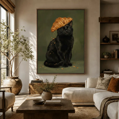Black cat croissant portrait canvas art hanging above a sofa in a boho-organic living room