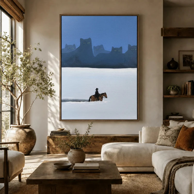 Oversized surreal western cat canvas in floater frame above a white sofa in a sunlit organic modern living room