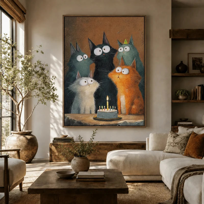 Five funny wide-eyed cats around a birthday cake — large canvas art above a sofa in a cozy living room
