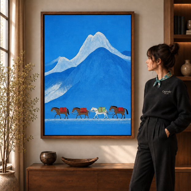 Walnut-framed snowy mountain landscape painting with pack horses beside a sunlit window and credenza.