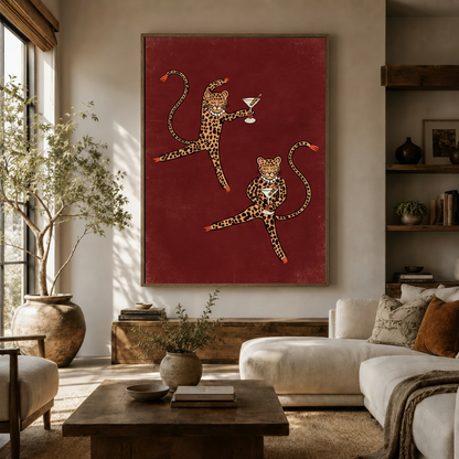 Large cocktail leopards boho wall art hung above a cream sofa in a bright, earthy living room with natural light