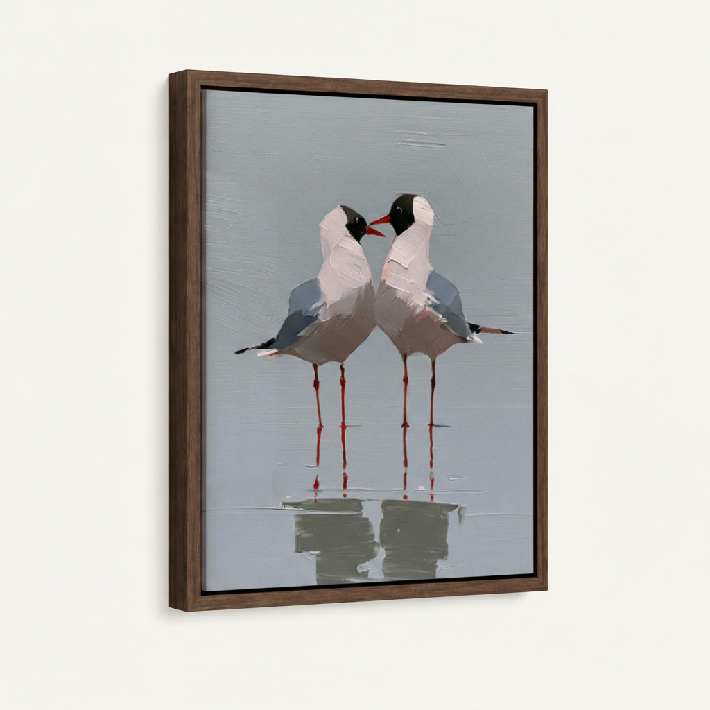 Framed canvas of two black-headed seagulls face to face in dark walnut floating frame, angled side view showing canvas depth