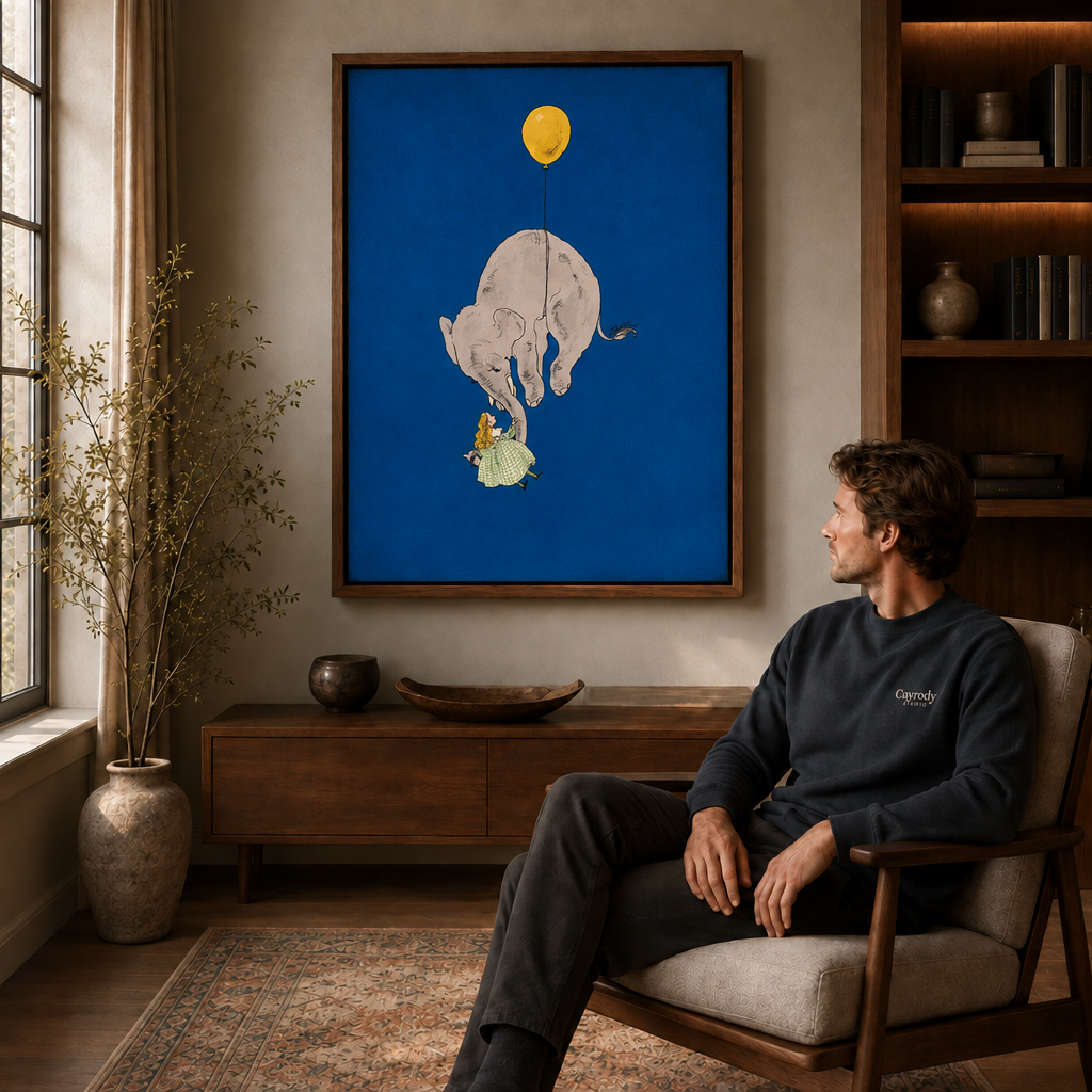 Walnut-framed whimsical elephant canvas wall art above a cabinet beside a man seated in an armchair.