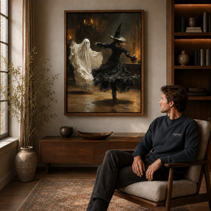 Candlelit witch and ghost wall art displayed above a wood cabinet beside a seated man.