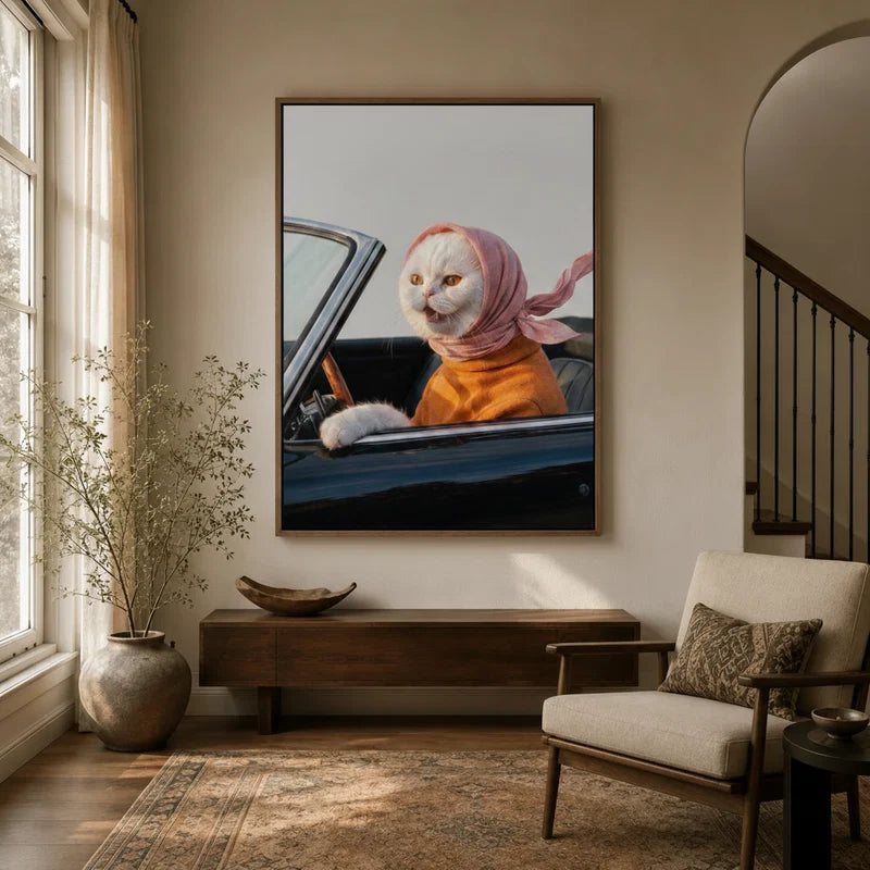 White cat in pink headscarf driving vintage car canvas art displayed in a warm neutral entryway with arched doorway