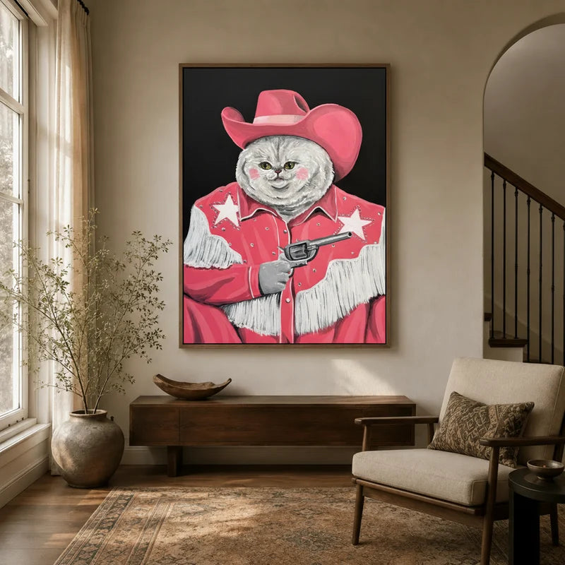 Pink cowgirl cat pop art canvas in floater frame displayed in warm neutral entryway with wood console and armchair