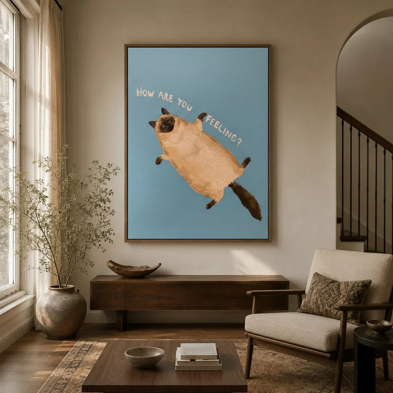 Funny cat wall art in walnut floater frame displayed in warm neutral entryway, chubby Siamese on blue background