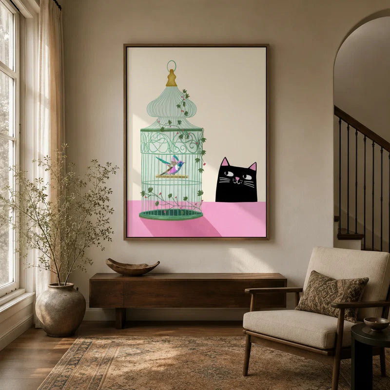 Black cat and birdcage whimsical canvas wall art in walnut frame displayed in bright neutral entryway