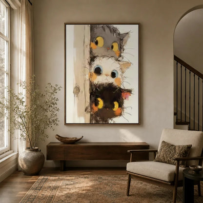Three curious cats peeking around a door canvas art displayed in a warm neutral entryway with console table