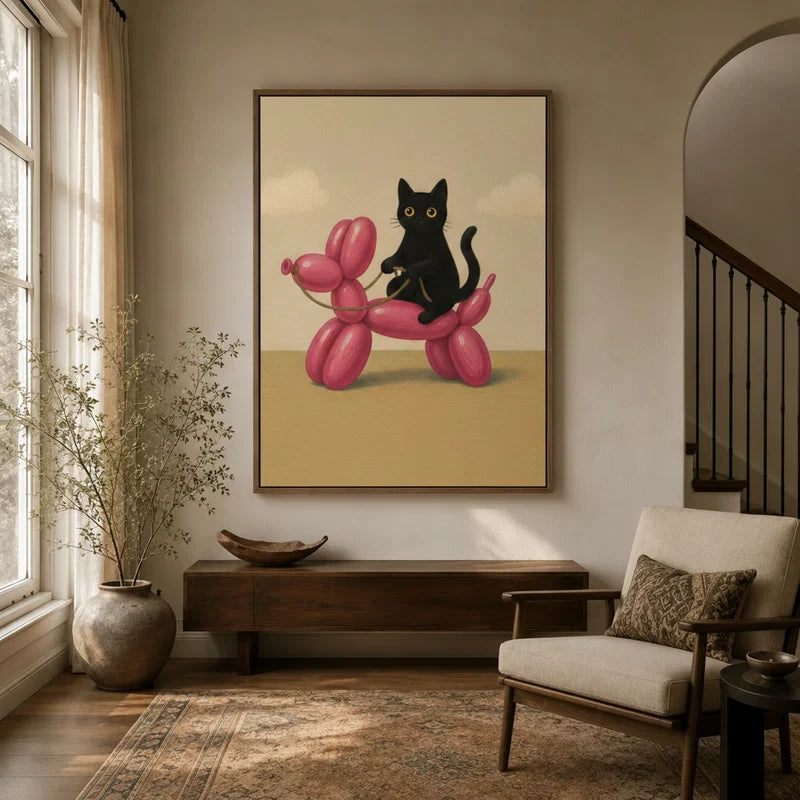 Black cat perched on pink balloon dog canvas wall art displayed in a warm entryway