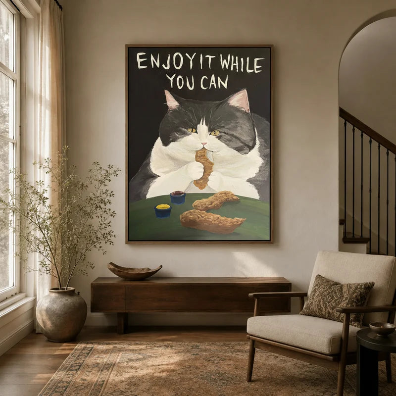 Framed tuxedo cat fried chicken canvas wall art with Enjoy It While You Can lettering in warm neutral entryway