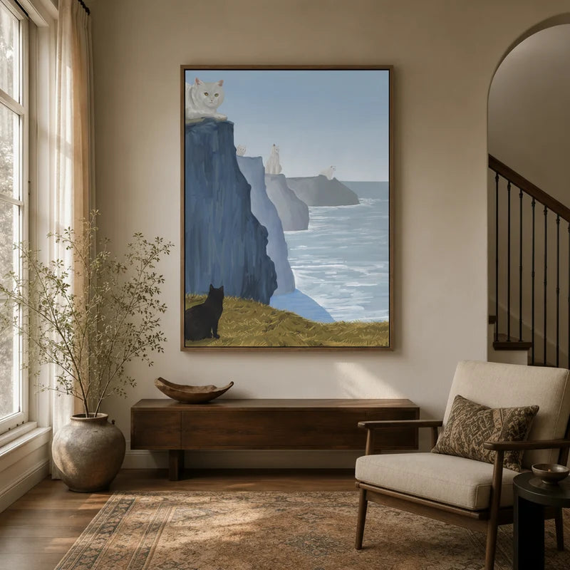 Framed cats on cliffs canvas wall art hung large in a warm neutral entryway with arched doorway and staircase