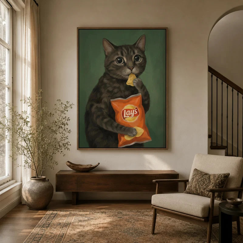 Framed tabby cat canvas wall art displayed in a bright neutral entryway with wood console and armchair