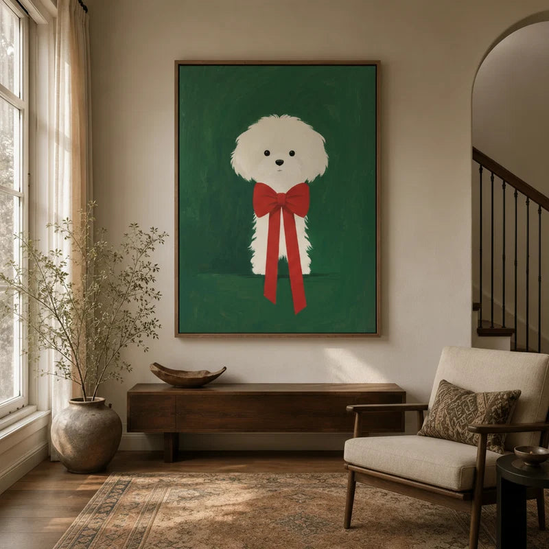 Minimalist white fluffy dog with red bow canvas art in a warm neutral entryway with wood console and armchair