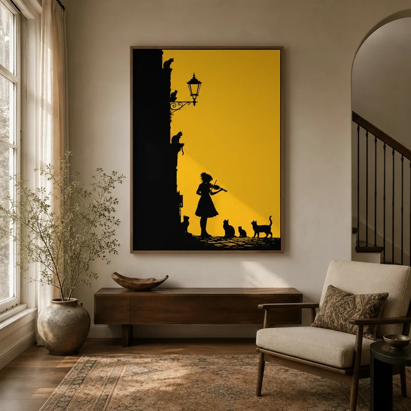 Golden yellow cat and violinist silhouette framed canvas hanging in a bright entryway with arched doorway and armchair