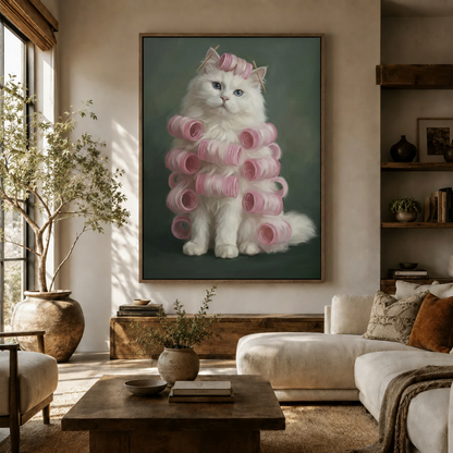 Whimsical fluffy cat in curlers framed canvas hanging in a cozy neutral living room with linen sofa