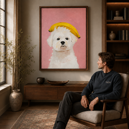Fluffy white dog with a banana on its head displayed above a seated man.