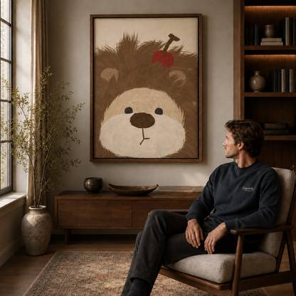 Man seated in an armchair beside a walnut floating-frame wall art of a fluffy brown dog with a red apple.