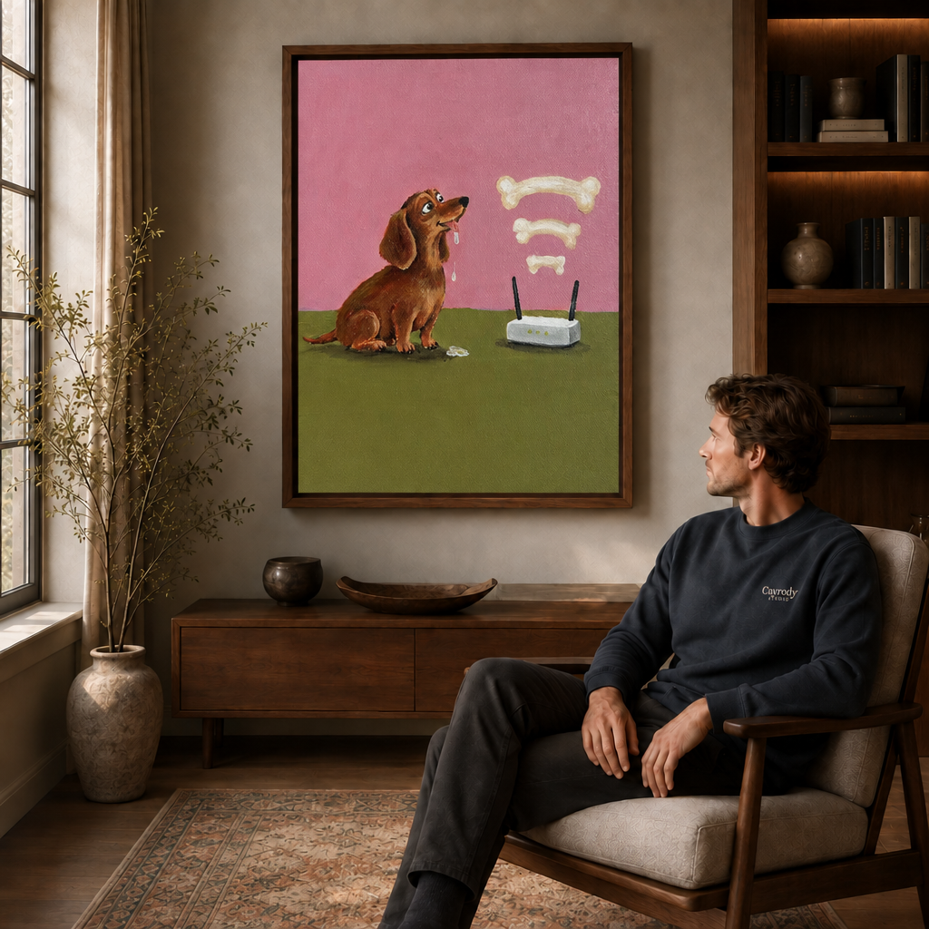 Man seated in an armchair gazing at framed dachshund canvas wall art above a wooden sideboard.
