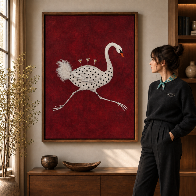 a walnut-framed whimsical canvas of a polka-dot swan with martini glasses on a deep red background.