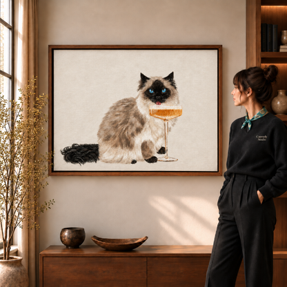 Fluffy blue-eyed cat with champagne glass, whimsical cat wall art in walnut frame.
