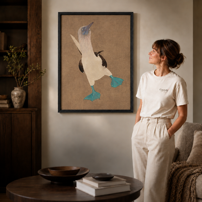 a black-framed blue-footed booby canvas wall art with teal feet.