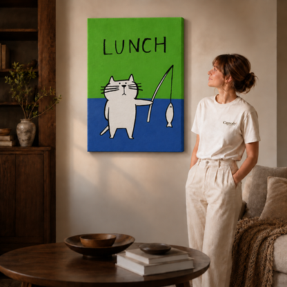 Woman in a cream tee standing next to a gallery-wrapped canvas showing a white cat fishing LUNCH illustration.
