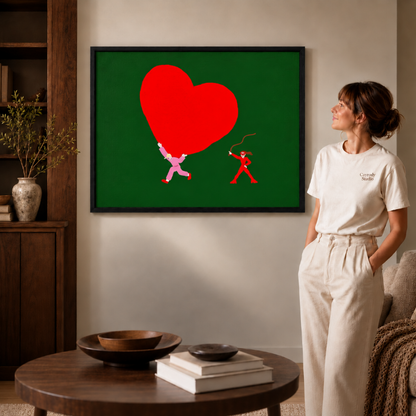 Red heart artwork in a black frame in white and a round table.