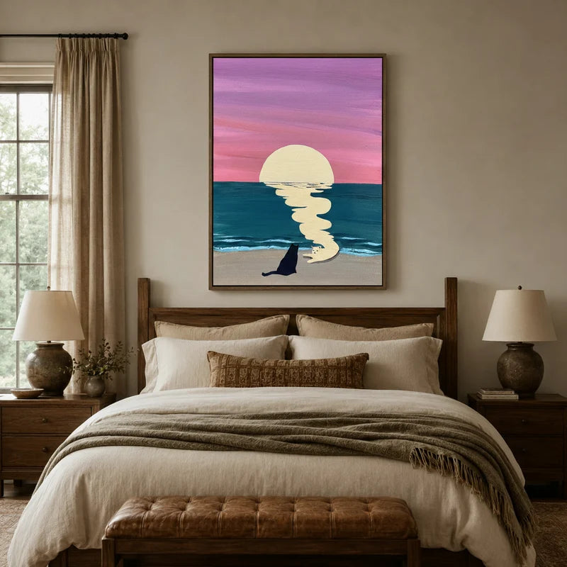 Two cats watching ocean sunset canvas wall art above a wooden bed headboard in a warm neutral bedroom setting