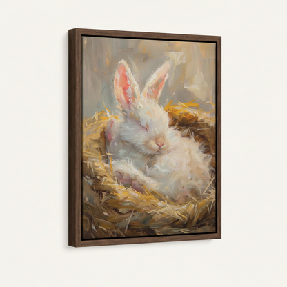 Framed sleeping bunny straw nest canvas print in dark walnut float frame on soft off-white background