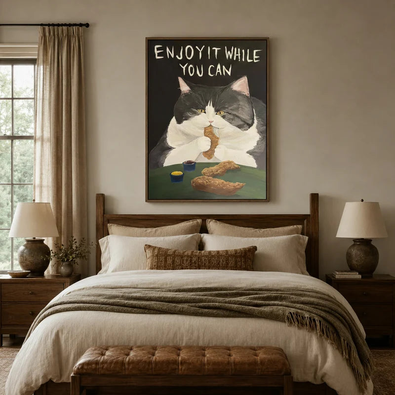 Enjoy It While You Can tuxedo cat canvas wall art above a wooden bed headboard in a warm neutral bedroom