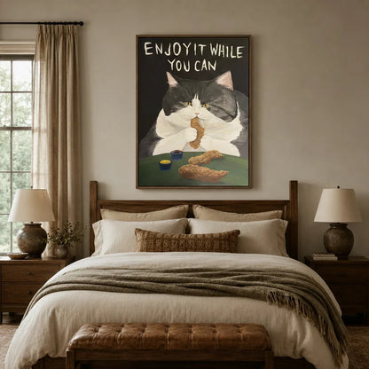 Enjoy It While You Can tuxedo cat canvas wall art above a wooden bed headboard in a warm neutral bedroom