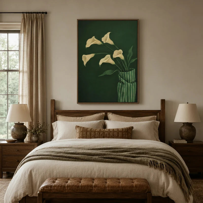 Elegant calla lily botanical canvas hanging above wooden bed in a rustic bedroom with linen bedding and warm lamps