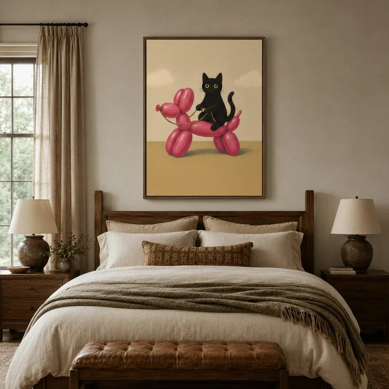 Black cat riding pink balloon dog wall art above a cozy neutral bedroom headboard