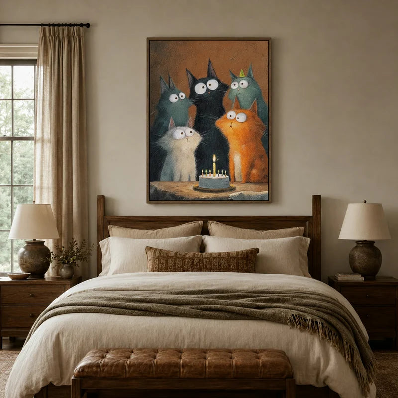 Whimsical cat birthday cake wall art hanging above a linen bed in a warm neutral bedroom