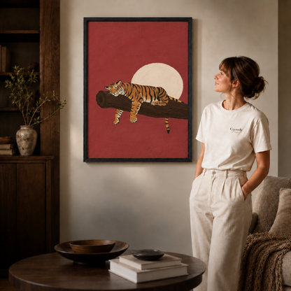 a black-framed sleeping tiger canvas print above a console.