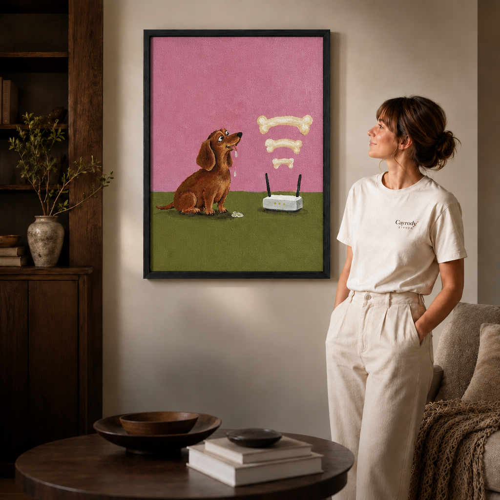 Woman in a white tee standing beside a black-framed dachshund canvas in a softly lit living room.
