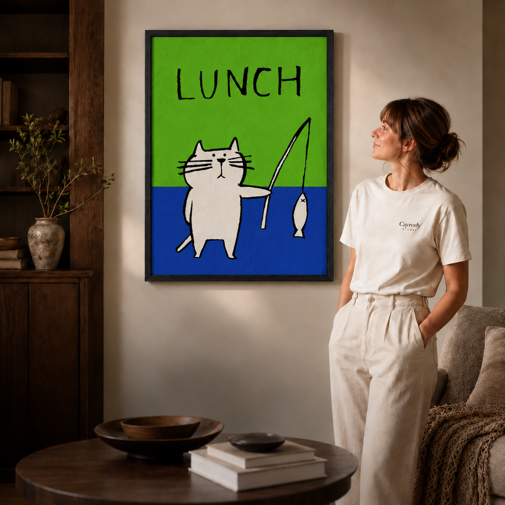 Woman admiring a thin black framed white cat fishing LUNCH artwork in a cozy modern living room.