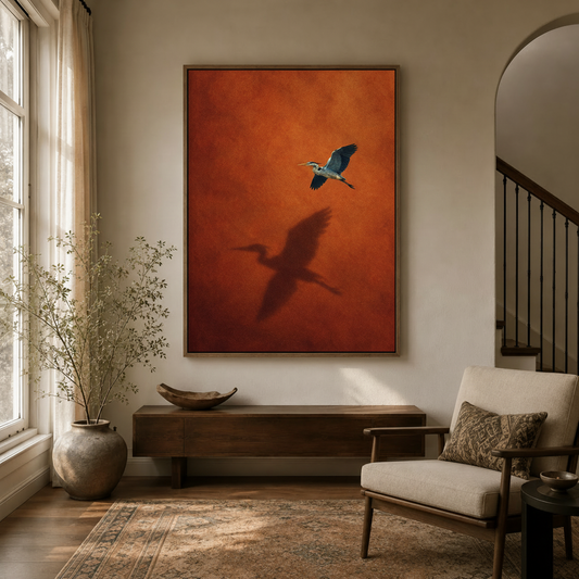 Flying heron shadow canvas wall art in walnut frame displayed above console table in warm neutral entryway
